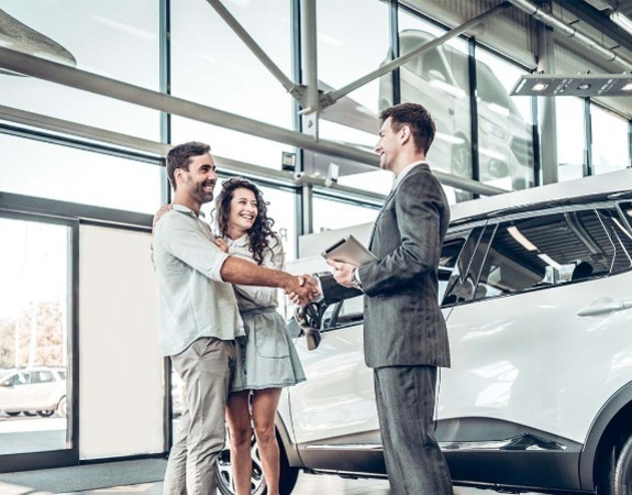 Dealership sales representative with customers