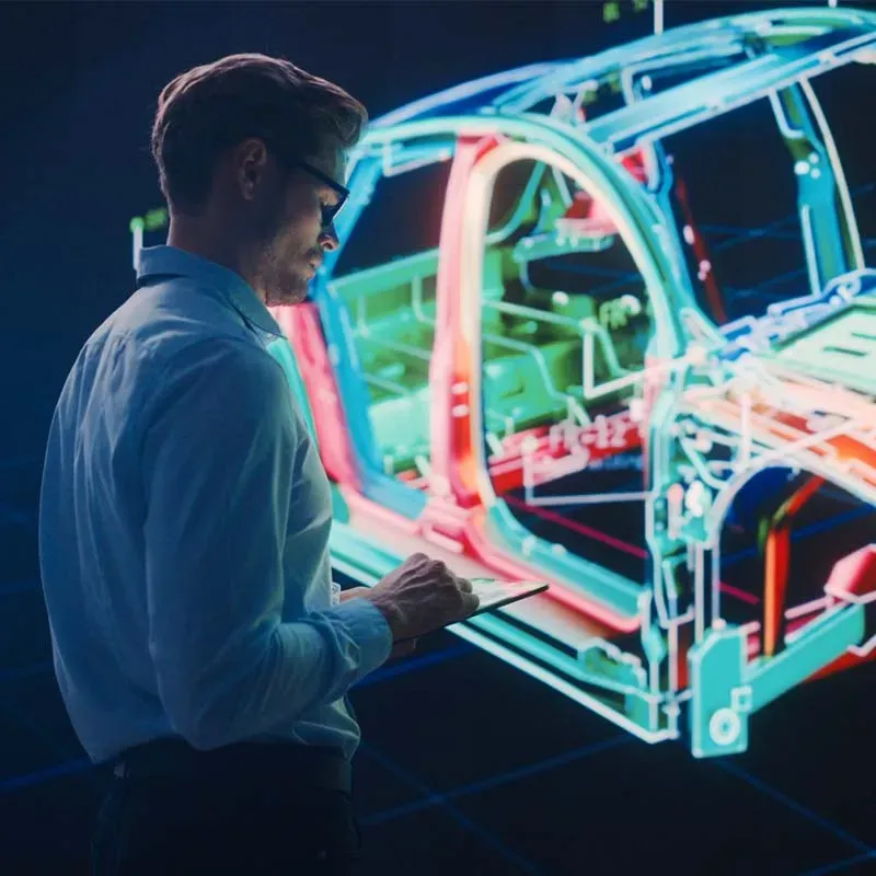 Man looking at car body with tablet in his hand